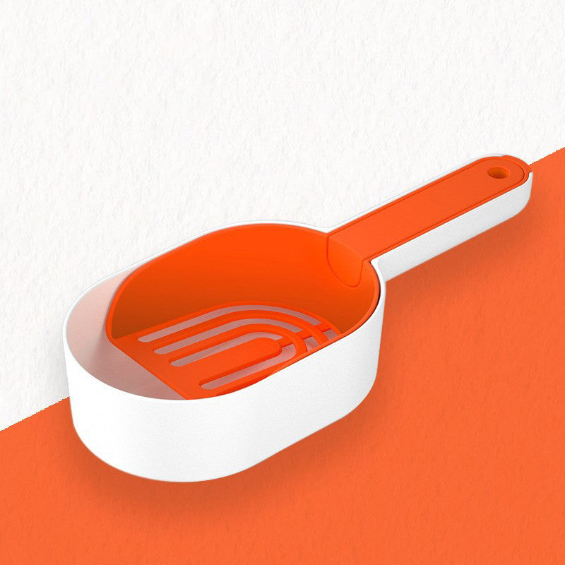 Orange and white pet scoop on an orange surface with a white background