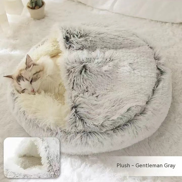 Fluffy gray pet bed with a cat inside on a light background