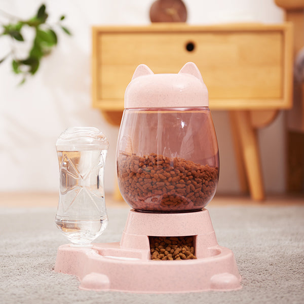 Pink pet feeder with a water bottle on a carpeted floor.