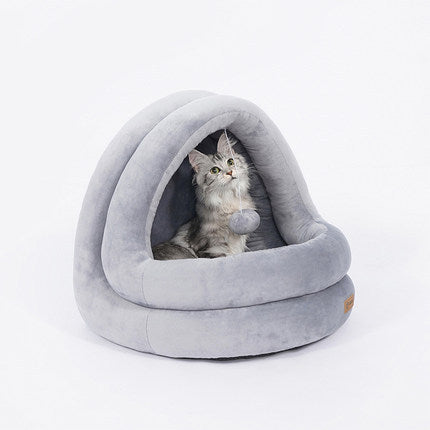 Gray pet bed with a cat peeking out on a white background