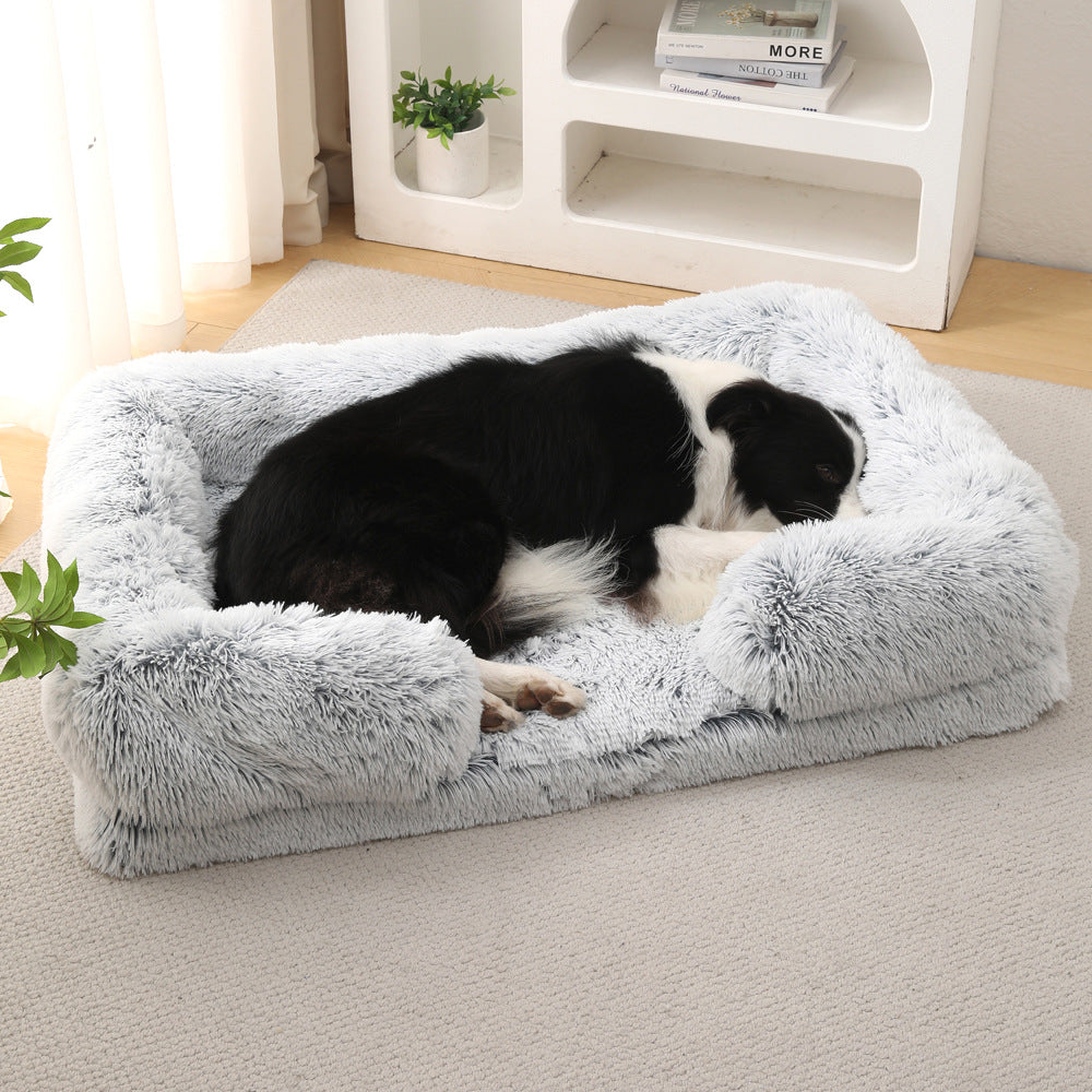 Dog lying on a fluffy gray pet bed in a cozy living room.