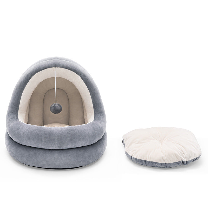 Gray and white pet bed with a hanging ball on a white background