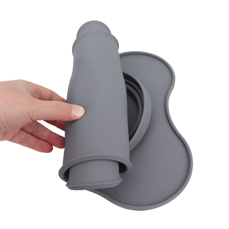 Gray silicone mat with a hand holding it on a white background