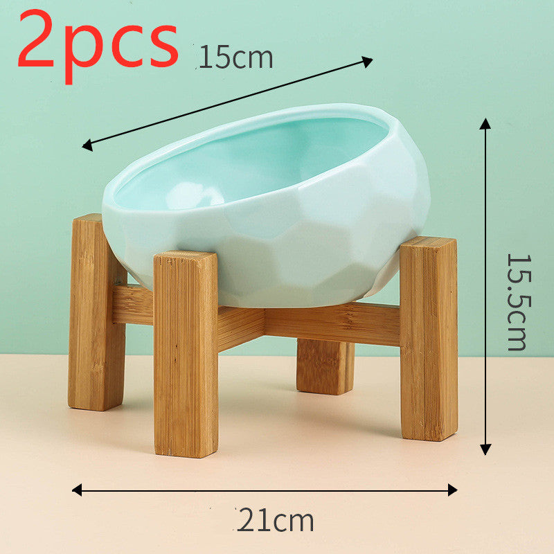 Flat lay of tilted ceramic cat and dog bowl showing ergonomic feeding design