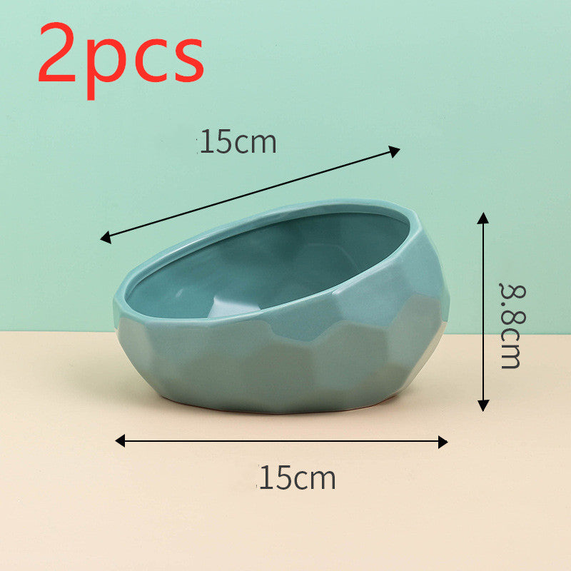 Cat eating from angled ceramic bowl designed to reduce neck strain during meals