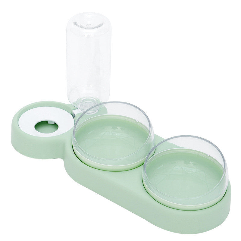 Dog drinking water from automatic pet fountain bowl during feeding time