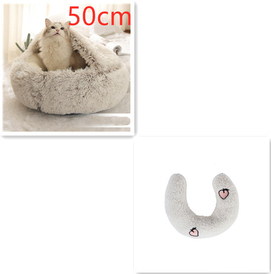 Cat bed with a cat inside and a heart-shaped pillow on a white background