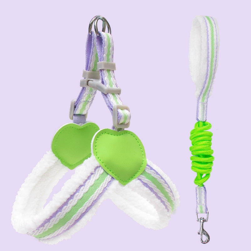 Pet harness and leash set with green heart-shaped tags on a light purple background