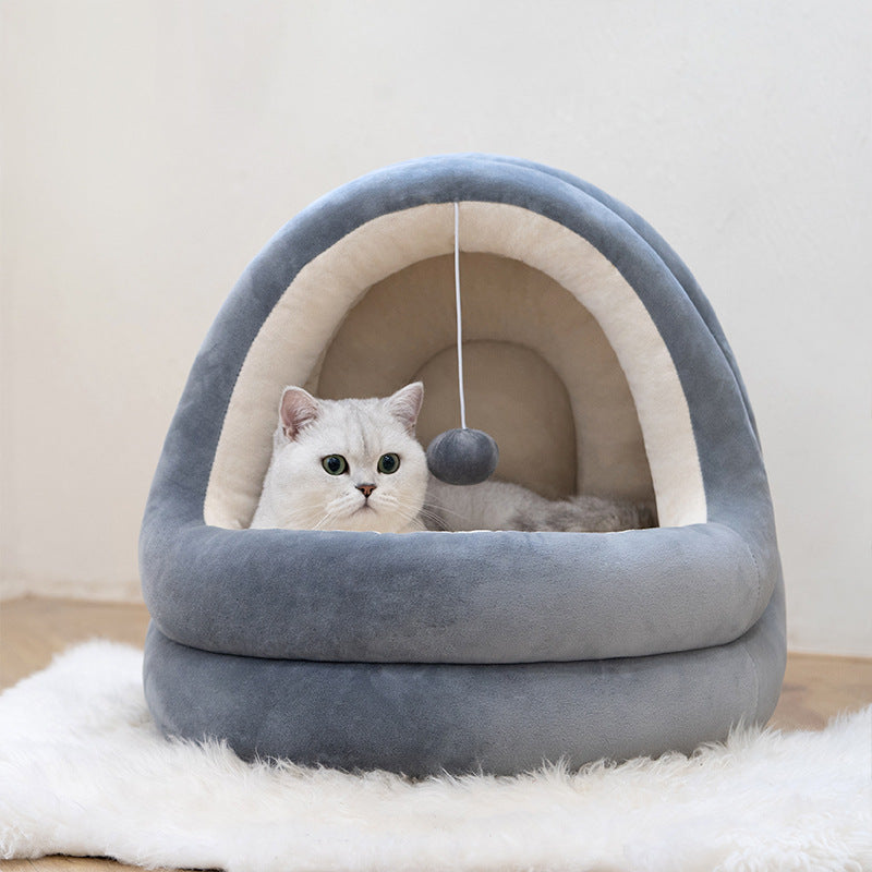 Cat lying inside a gray pet bed with a white background