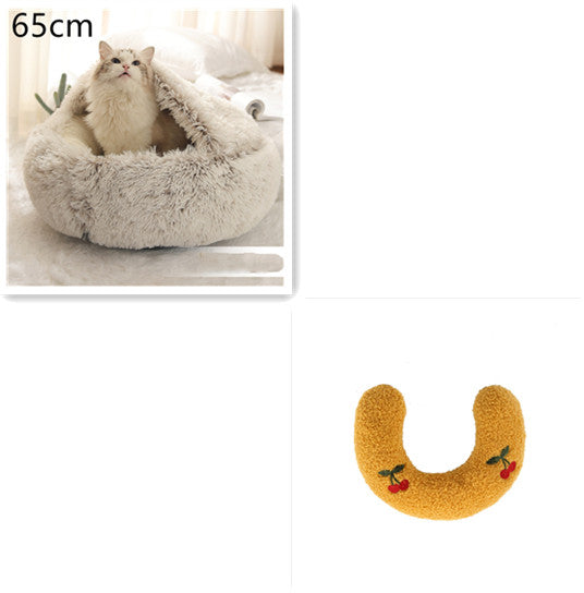Cat lying in a fluffy pet bed with a size indicator '65cm' on the left, and a yellow U-shaped cat toy with cherries on the right.