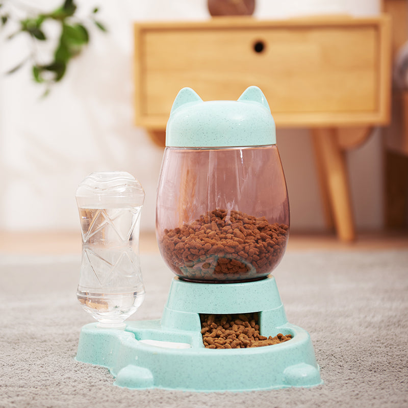 Pet feeder and water dispenser with cat ears on a carpeted floor.