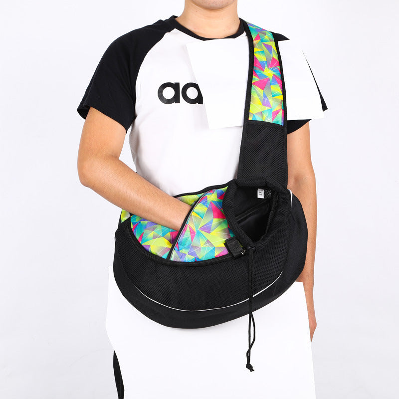 Person wearing a black and white shirt with a colorful geometric-patterned bag over their shoulder on a white background
