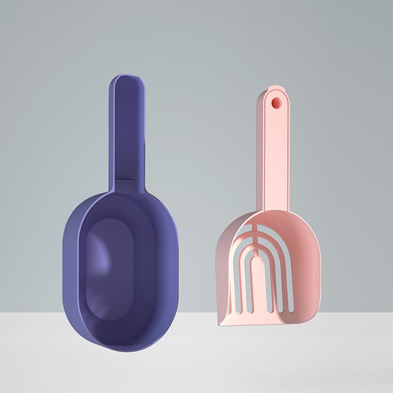 Purple scoop and pink spatula on a light gray background