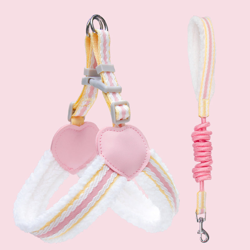 Dog leash and collar set with heart-shaped ends on a pink background