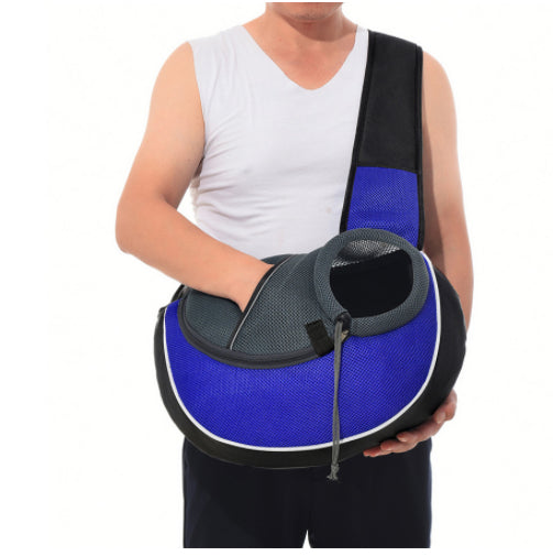 Person holding a blue and black pet carrier against a white background