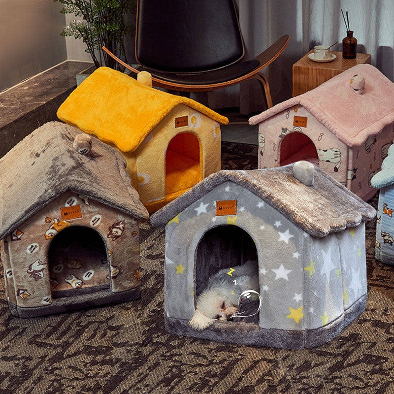 Four colorful pet houses on a carpeted floor with a small dog inside one of them.