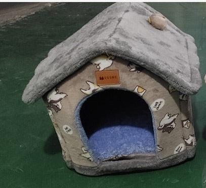 Gray pet house with cartoon designs on a green surface