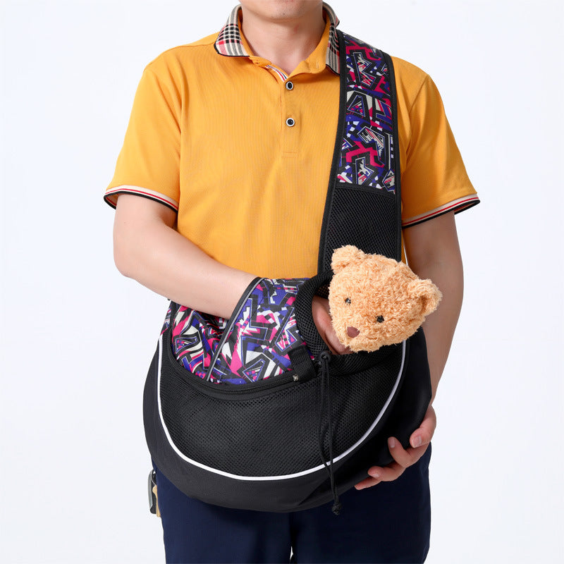 Person holding a black pet carrier with a teddy bear inside, against a white background