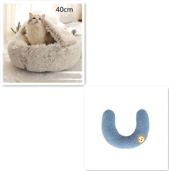 Cat lying in a fluffy pet bed with a blue U-shaped pillow on a white background.
