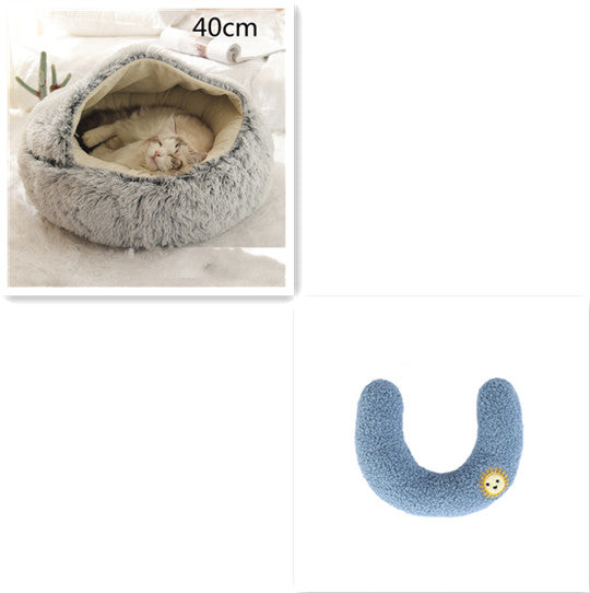 Cat bed with a cat inside and a blue U-shaped pillow on a white background