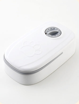 White electronic device with a circular component on a light gray background