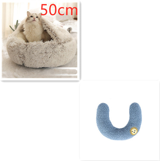 Cat bed with fluffy texture and a blue U-shaped pillow on a white background.