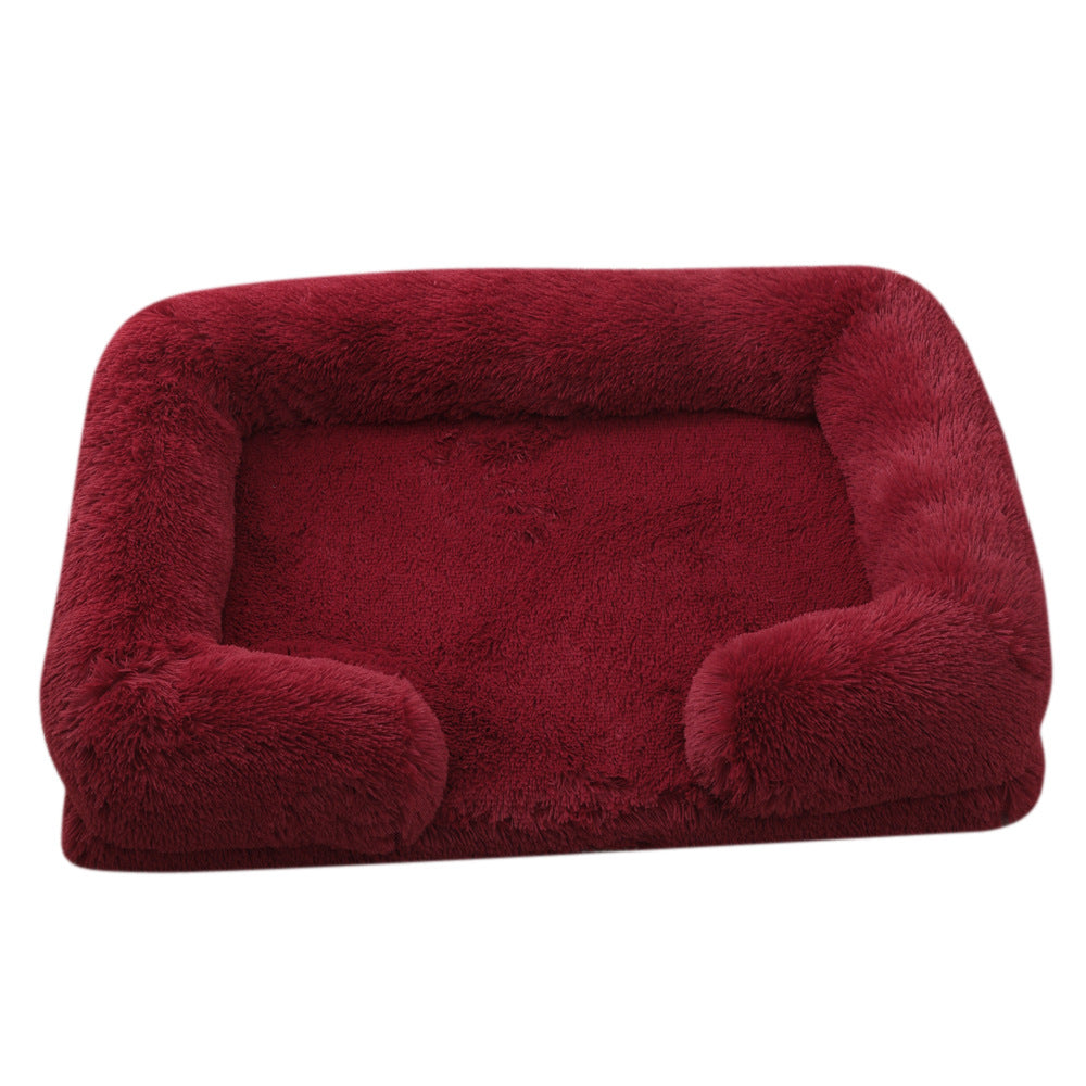 Red pet bed with plush texture on a white background