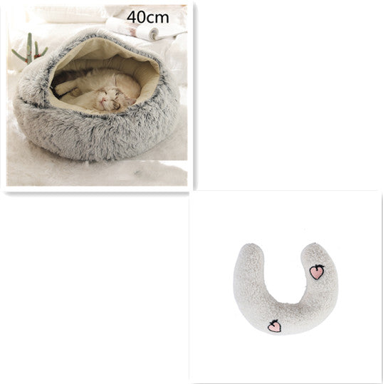 Fluffy pet bed with a cat inside and a matching heart-patterned pillow on a white background.