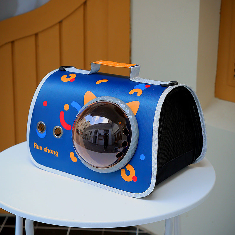 Blue pet carrier with colorful patterns on a white surface